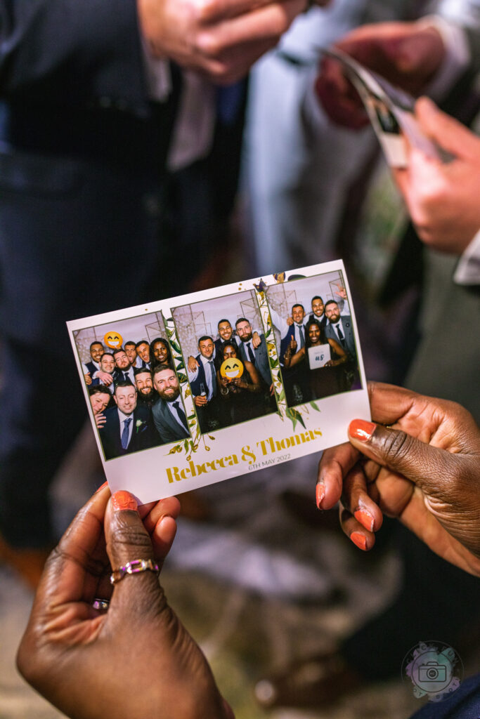 Hand holding a printed photo booth card