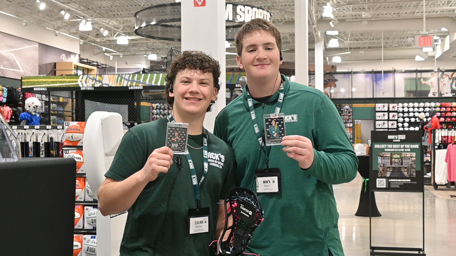 Two people in green shirts smiling for a photo