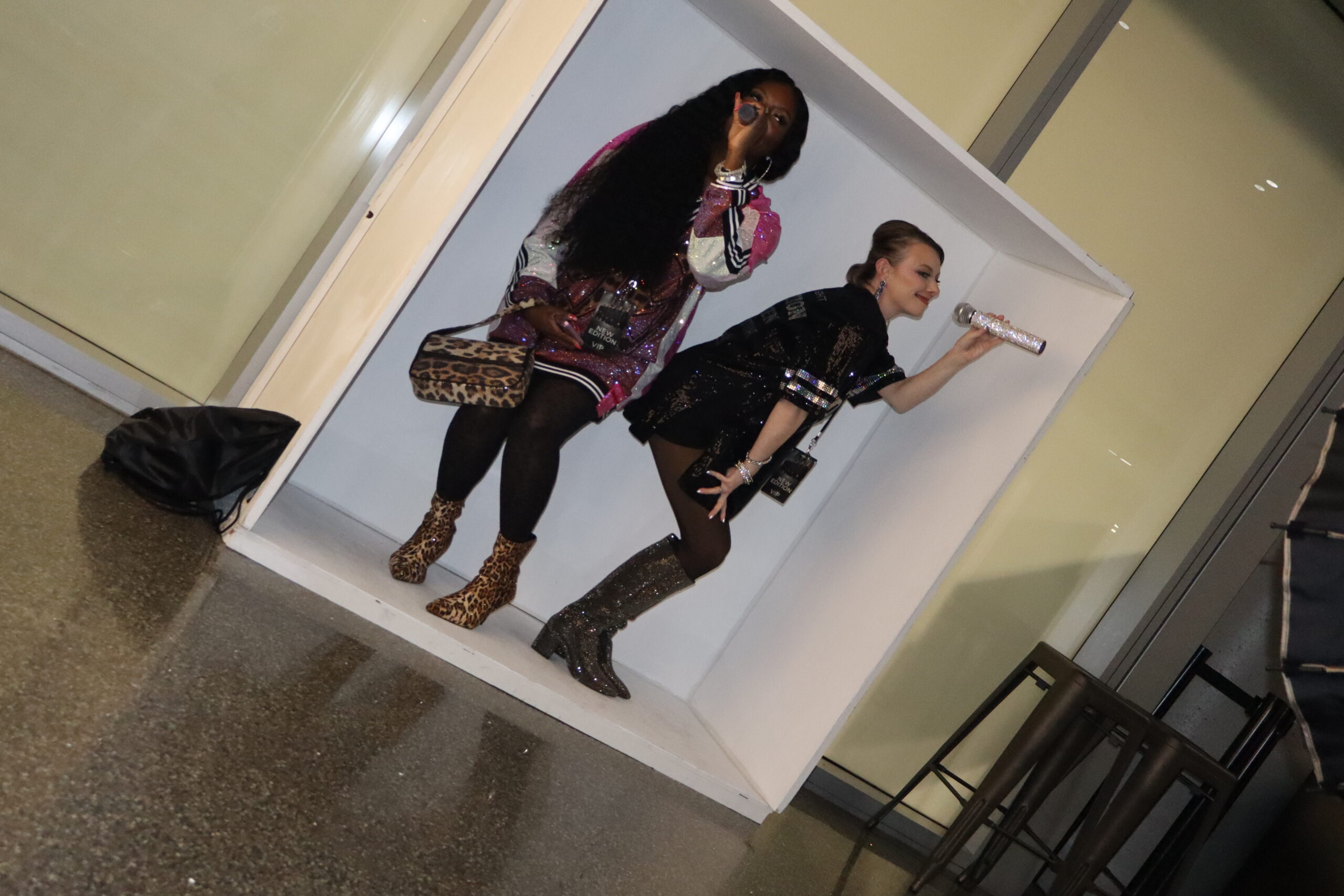Group posing playfully together in front of a photo booth screen