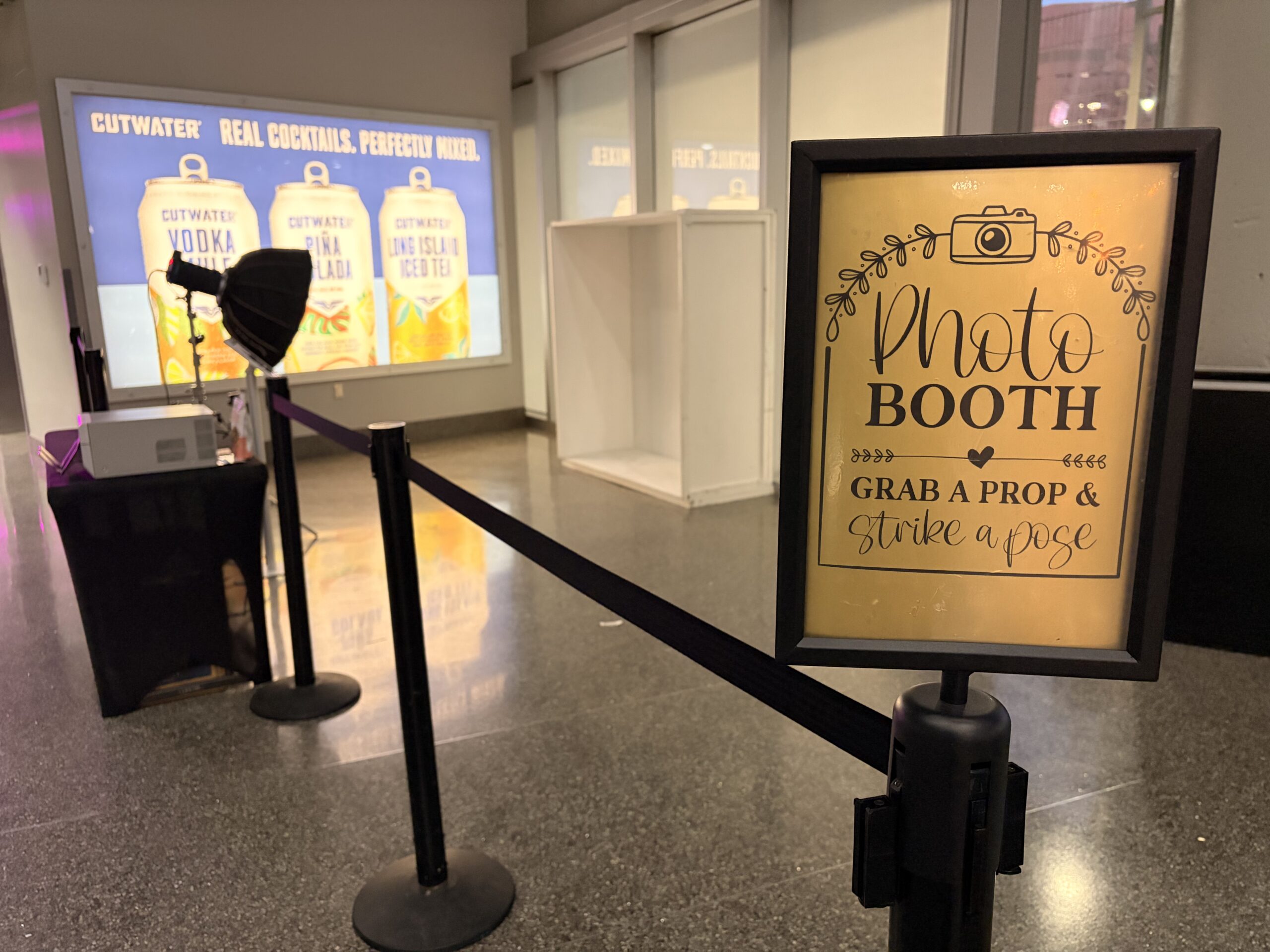 Photo booth kiosk station set up near a staircase indoors