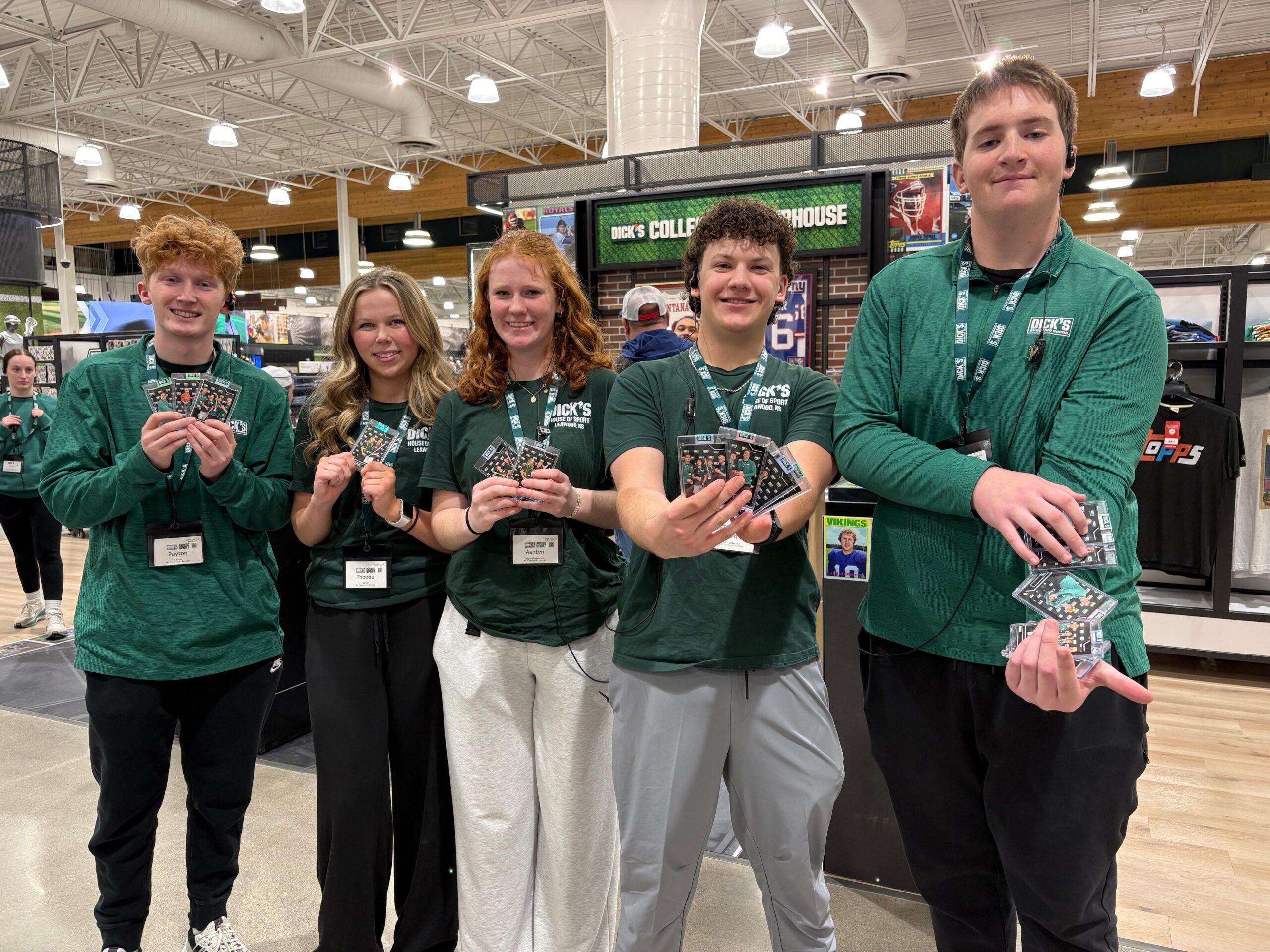 Group of people in green shirts posing together