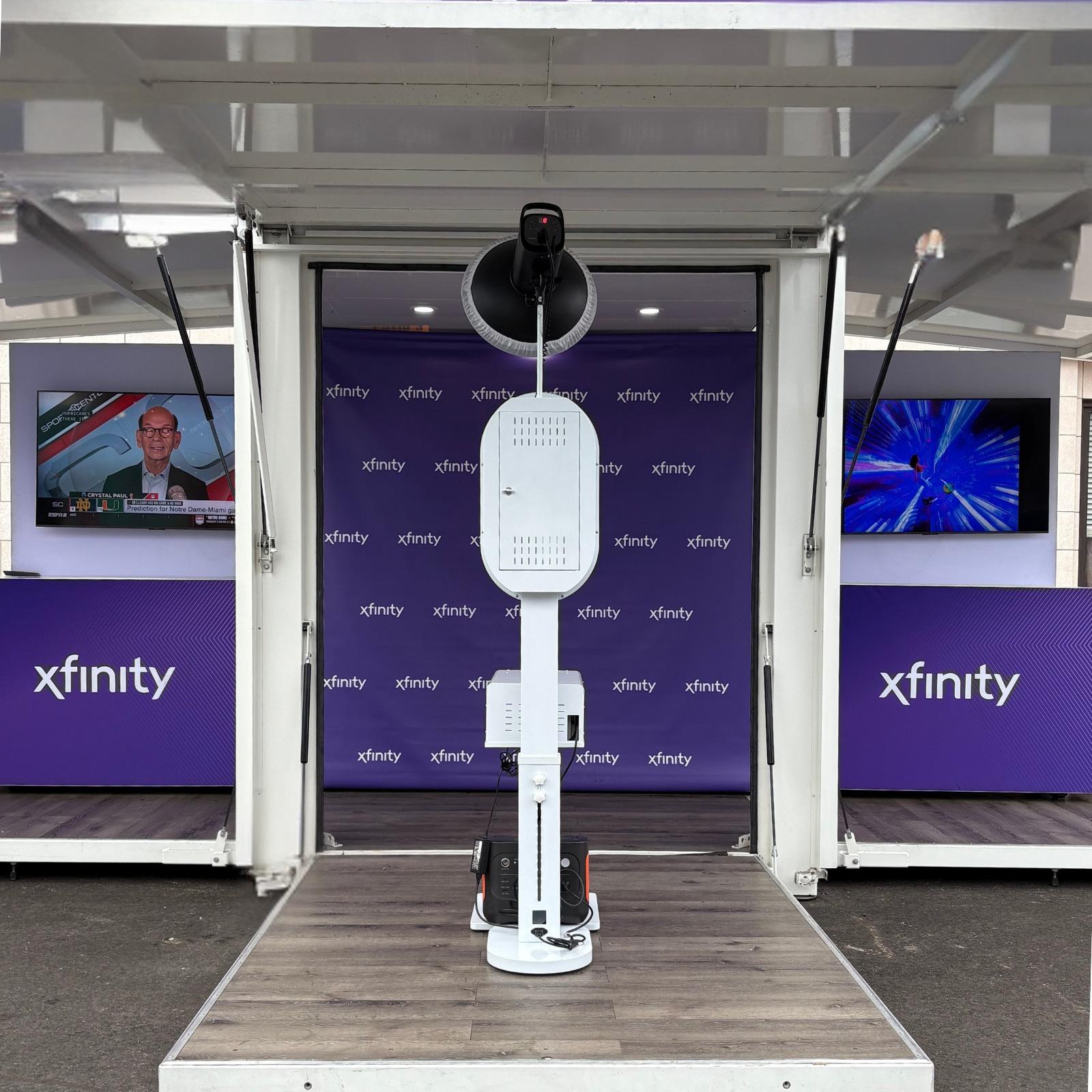 Person standing at a purple branded photo booth kiosk