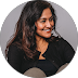 Woman smiling for a circular profile-style headshot