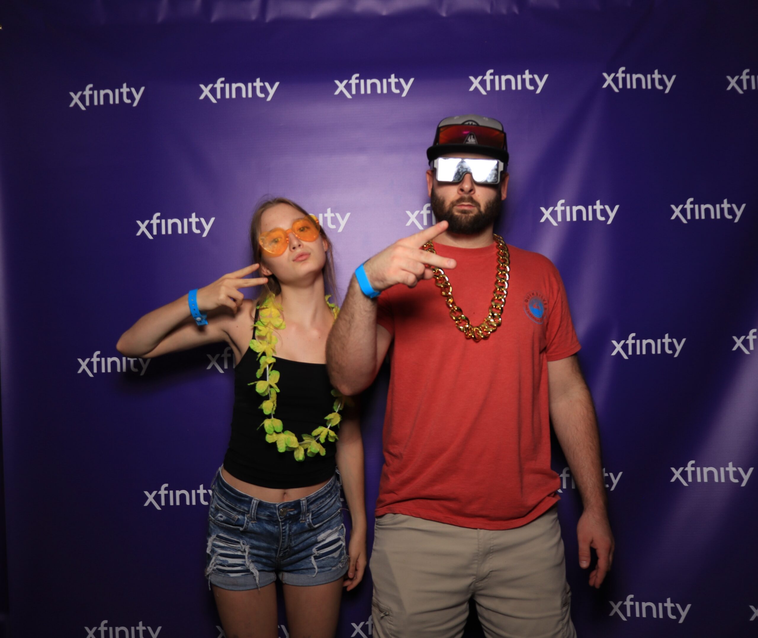 People posing together in front of a dark branded background