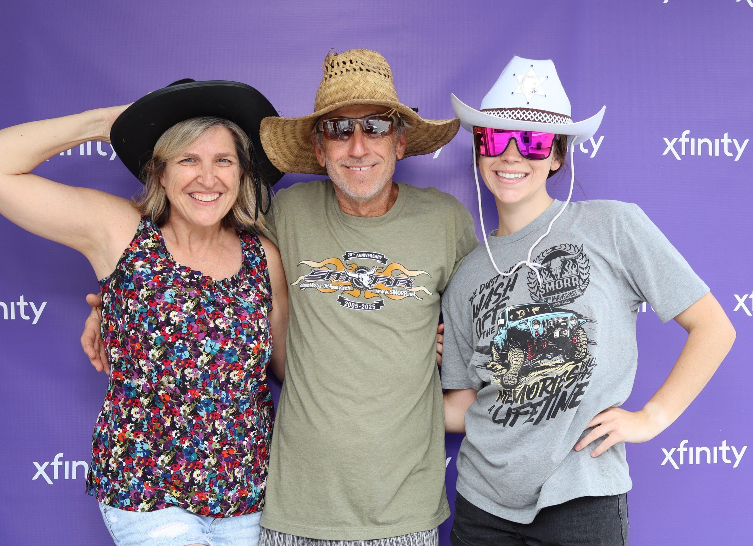 Group of women posing together outdoors wearing cowboy hats