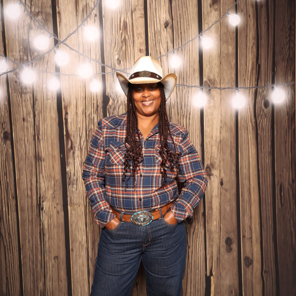 Person wearing a cowboy hat posing at an event