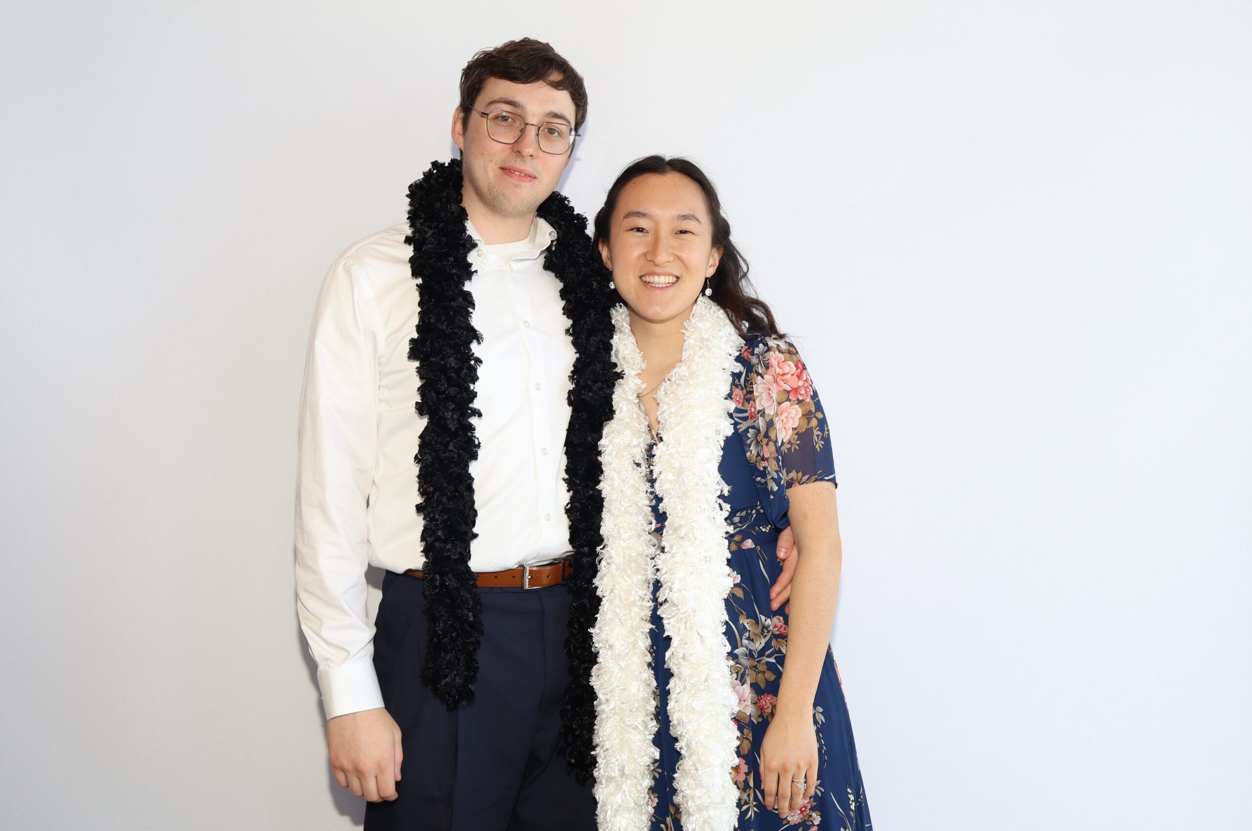 Man and woman posing together in formal attire