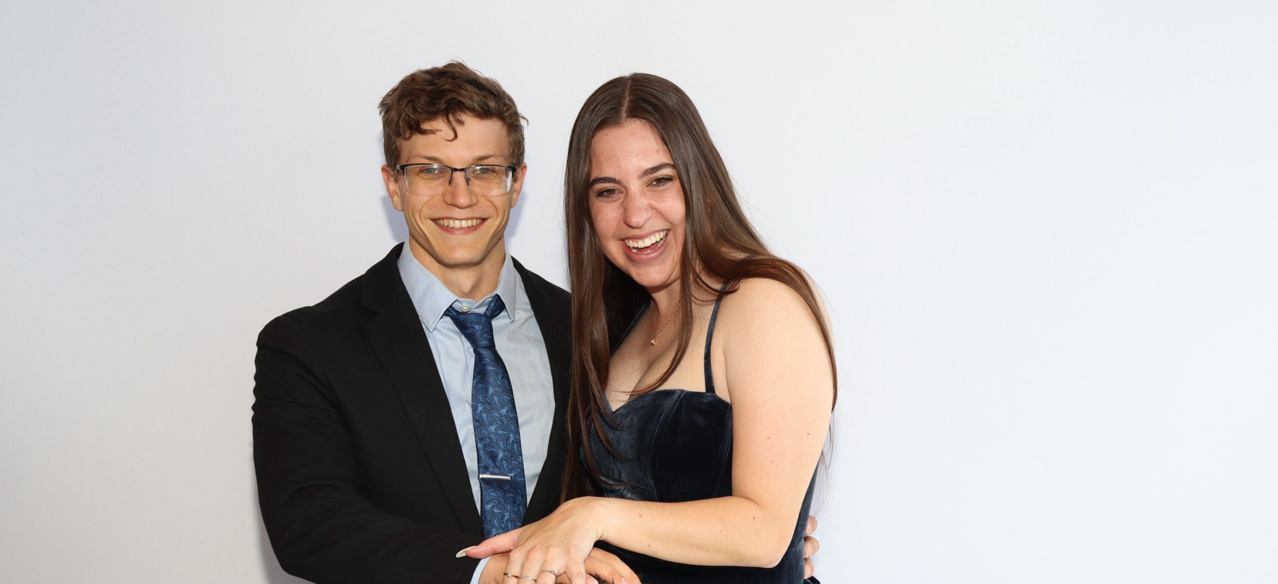 Man and woman posing together in formal attire
