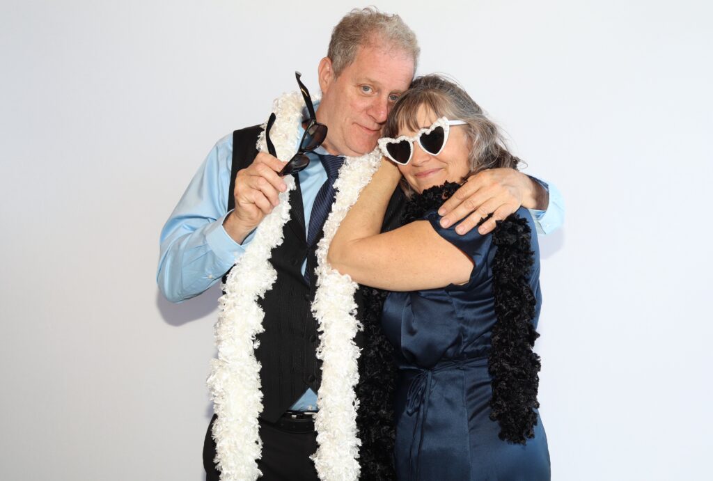 Man and woman posing together in formal attire