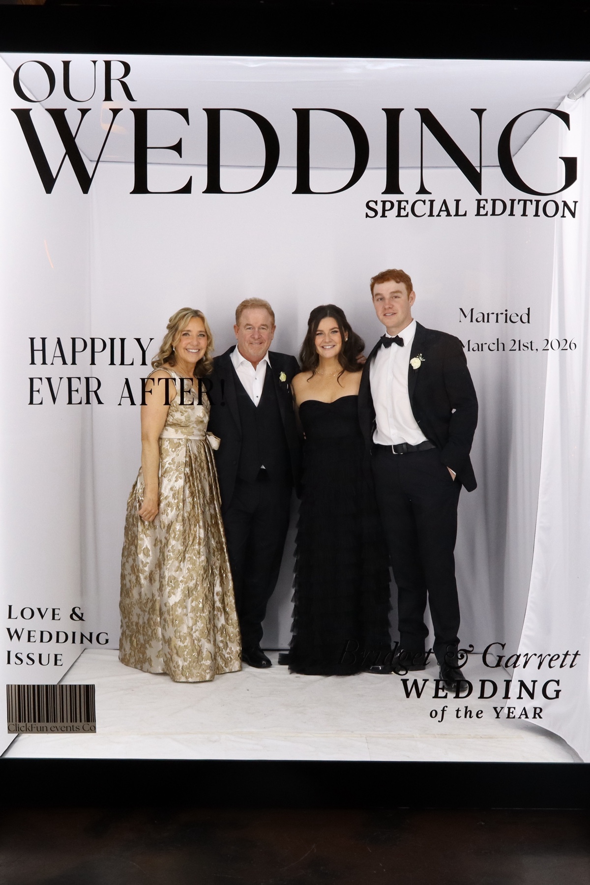 Group of women posing together in gowns at a wedding photo booth
