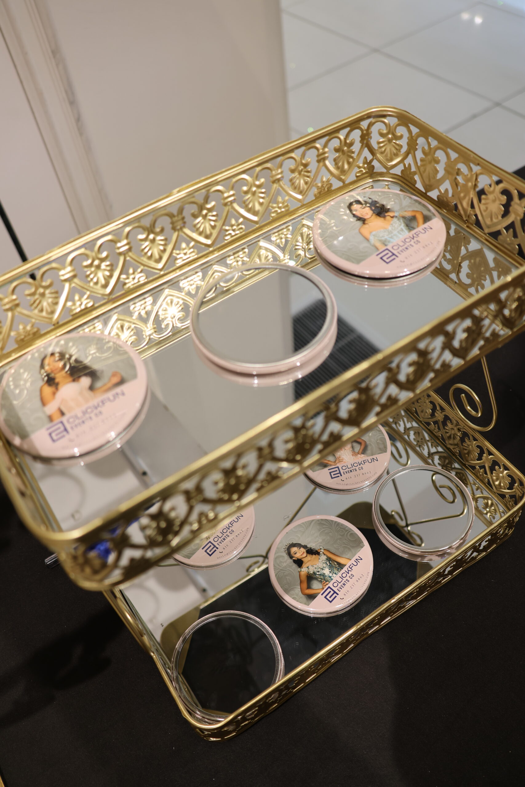 Display case with jewelry and printed photo cards