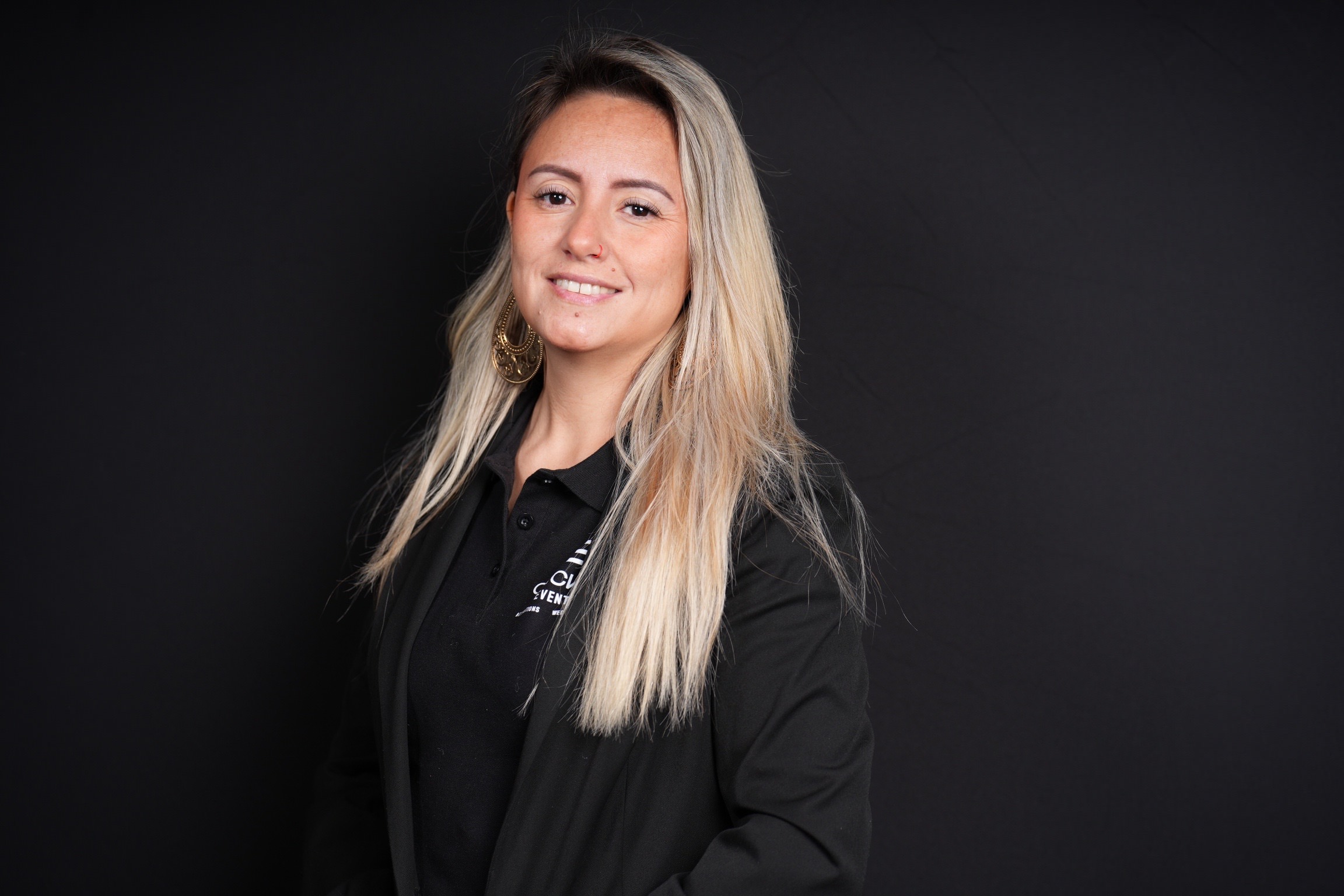 Woman with blonde hair smiling for a headshot
