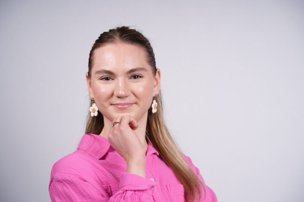 Woman in a pink top smiling for a headshot