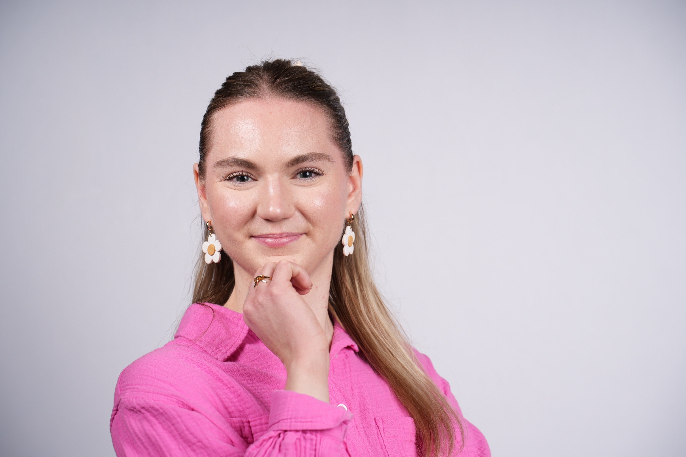 Woman in a pink top smiling for a headshot