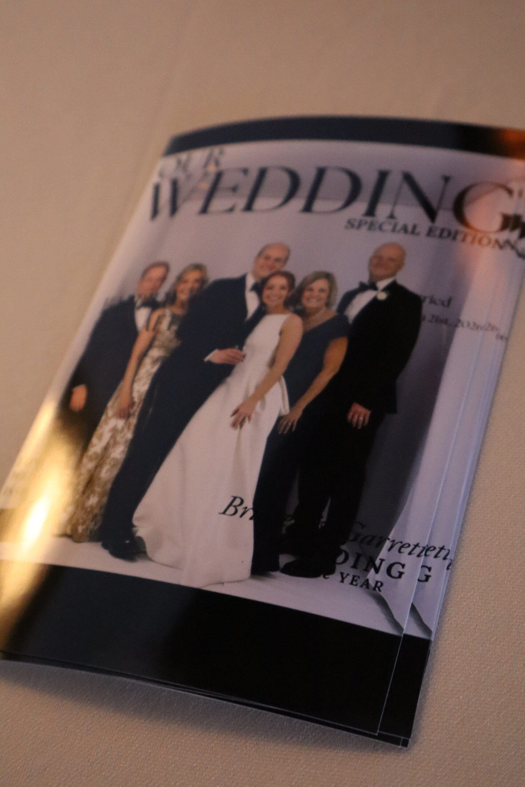 Group of people posing together at a wedding photo booth