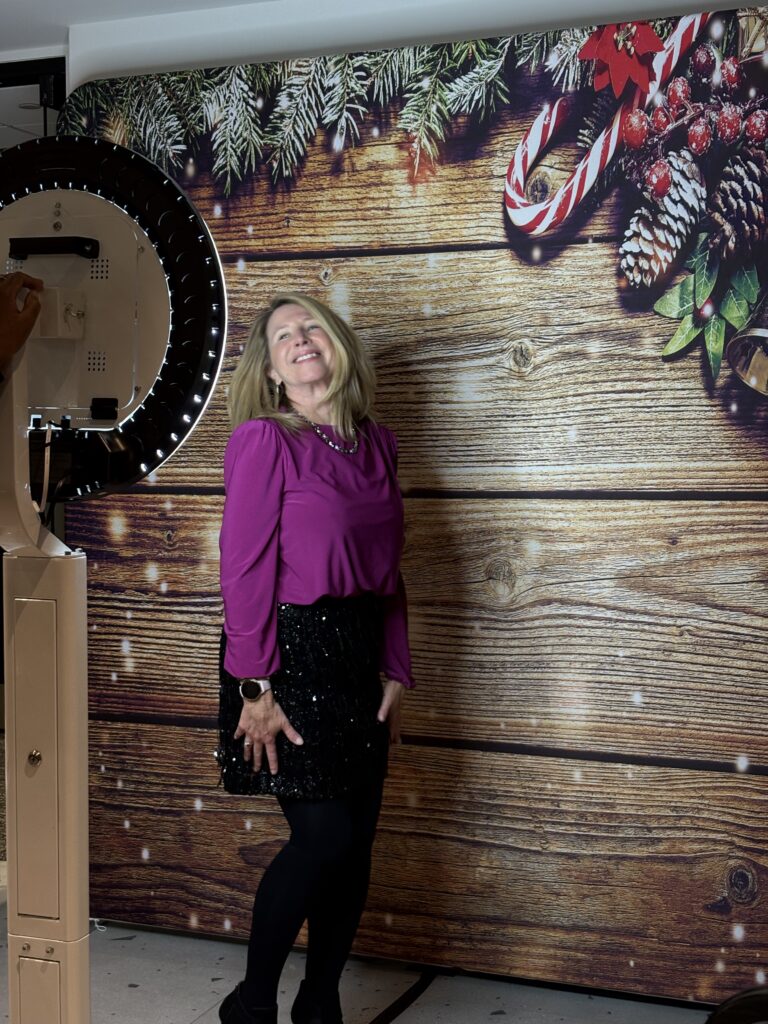 Woman posing alone against a wooden backdrop