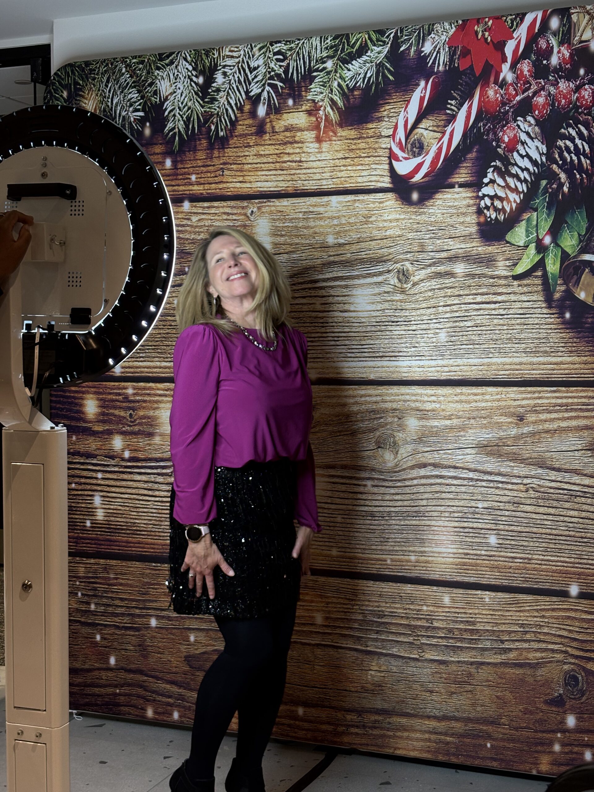 Woman posing alone against a wooden backdrop
